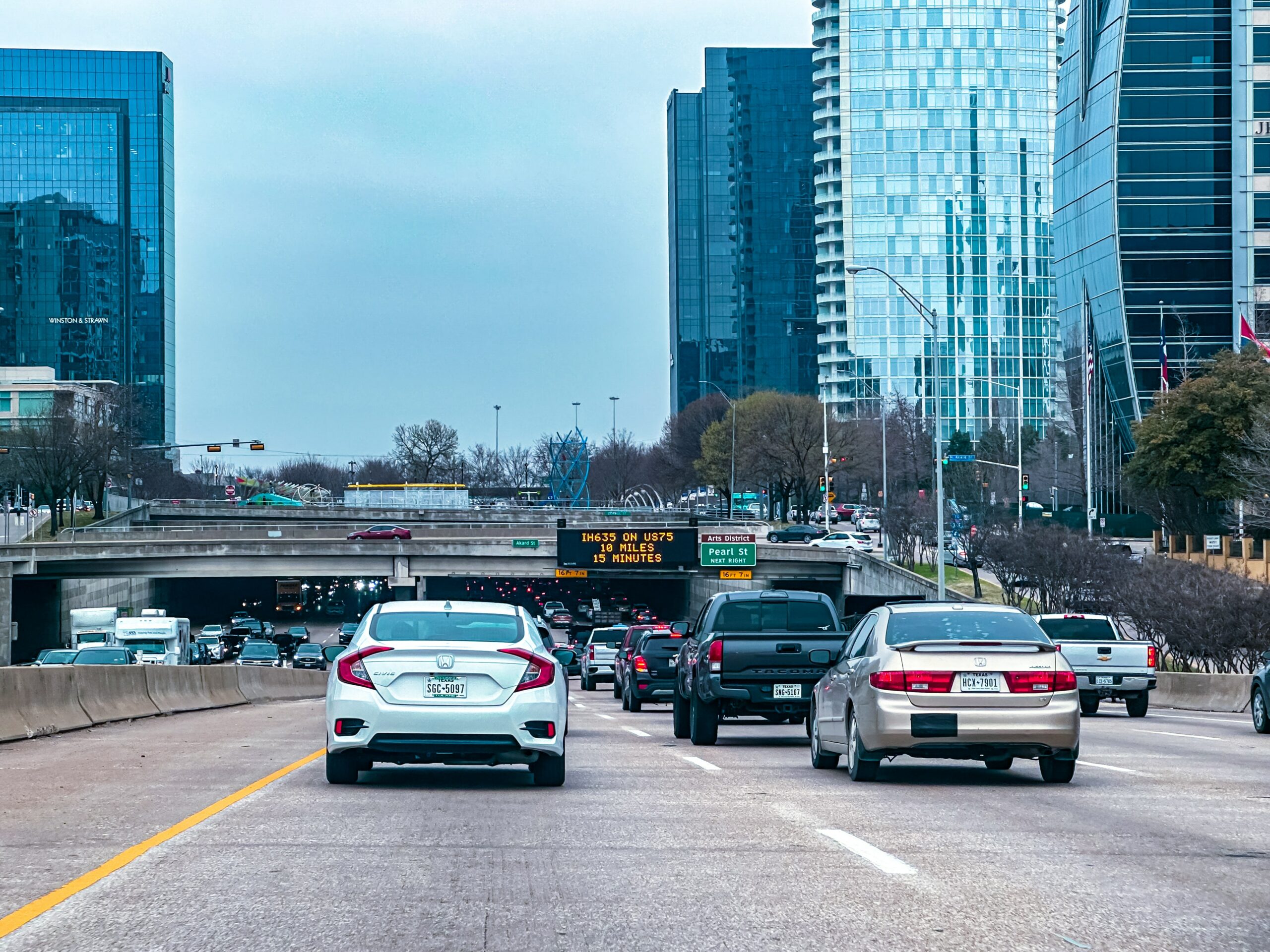Cars on the Woodall Rogers Freeway in Dallas approaching the tunnel underneath the Klyde Warren Deck Park